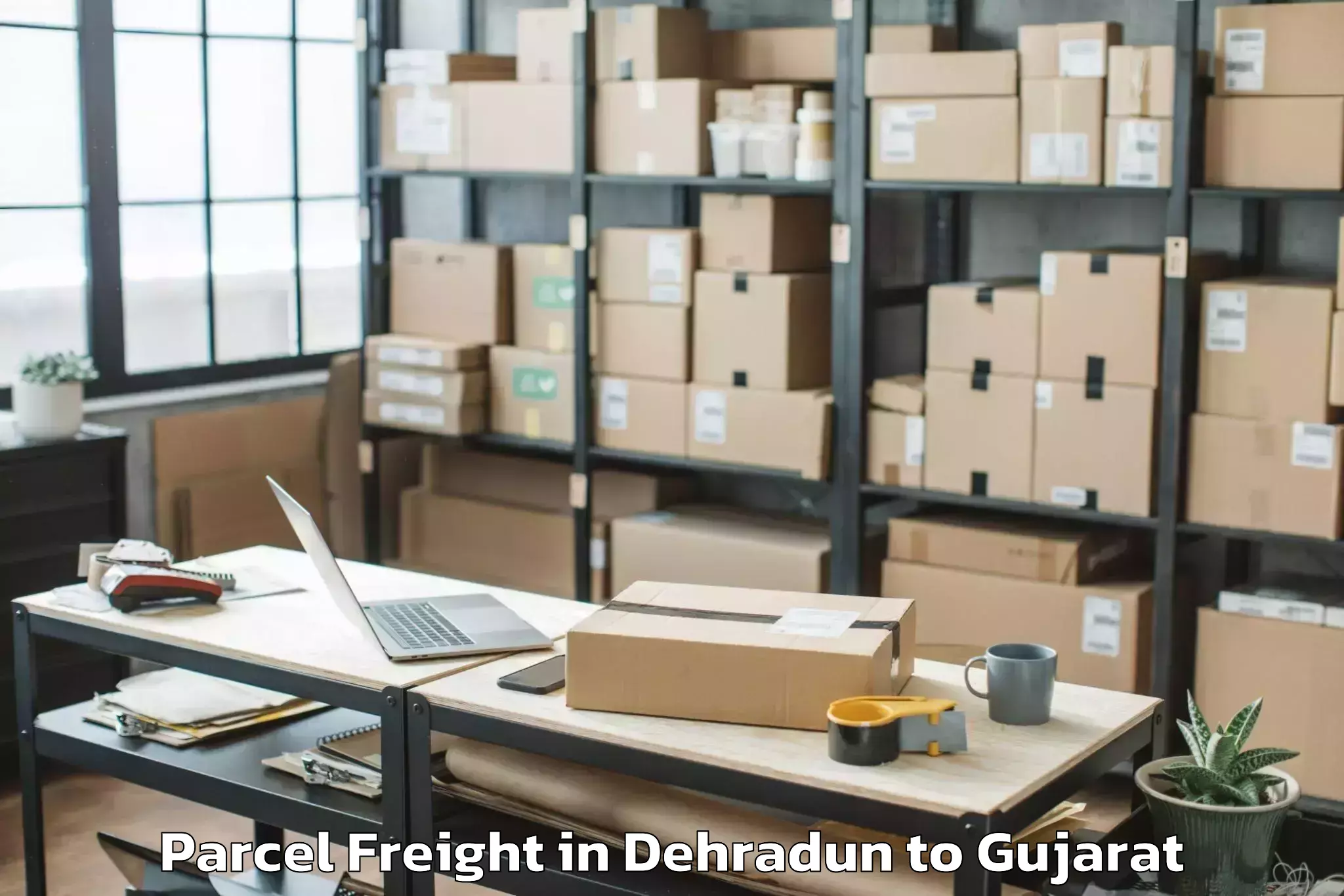 Leading Dehradun to Kamrej Parcel Freight Provider